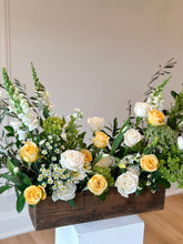 Load image into Gallery viewer, A wooden box arrangement of various flowers including roses, hydrangea, and snapdragons with a color combination of yellow, green, and white.