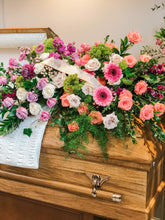 Load image into Gallery viewer, sympathy casket spray with bright roses, mauve roses, and greenery