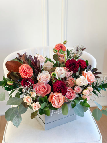 autumn floral arrangement in a grey square box