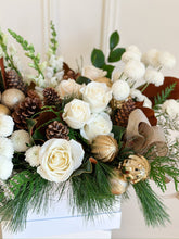 Load image into Gallery viewer, white hat box of flowers such as roses and button mums, with pinecones, gold ornaments, and winter greens.
