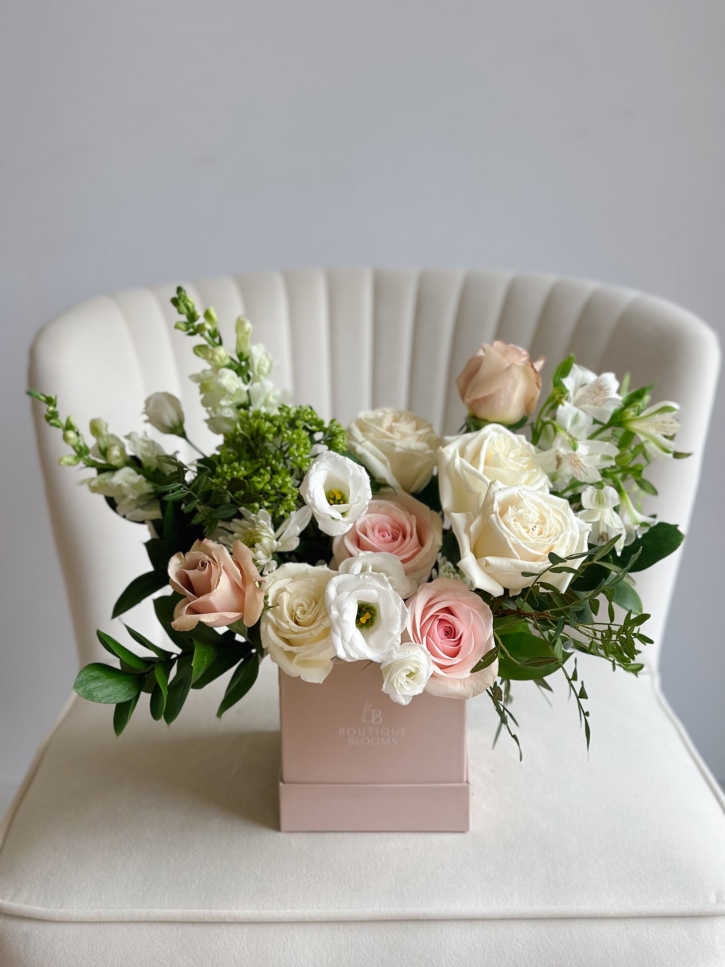 blush roses and white roses in a blush taupe hat box.