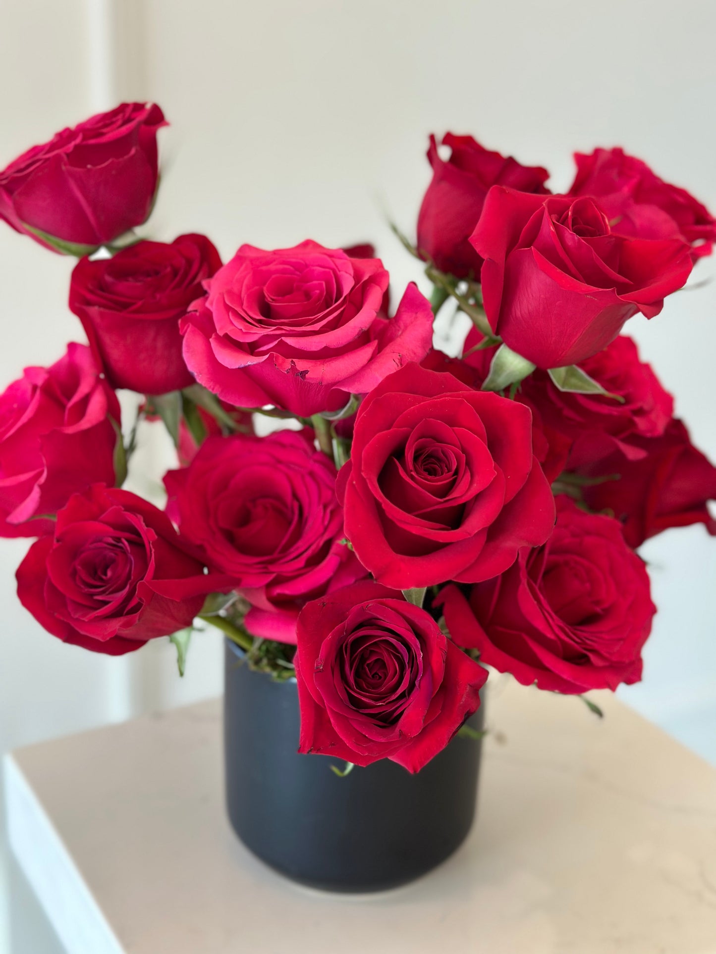 Valentines Day bouquet of red roses in a black vase 