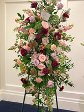 Load image into Gallery viewer, A collection of mixed floral such as roses, hypericum berries, carnations, snapdragons and mixed foliages designed into a funeral standing spray.
